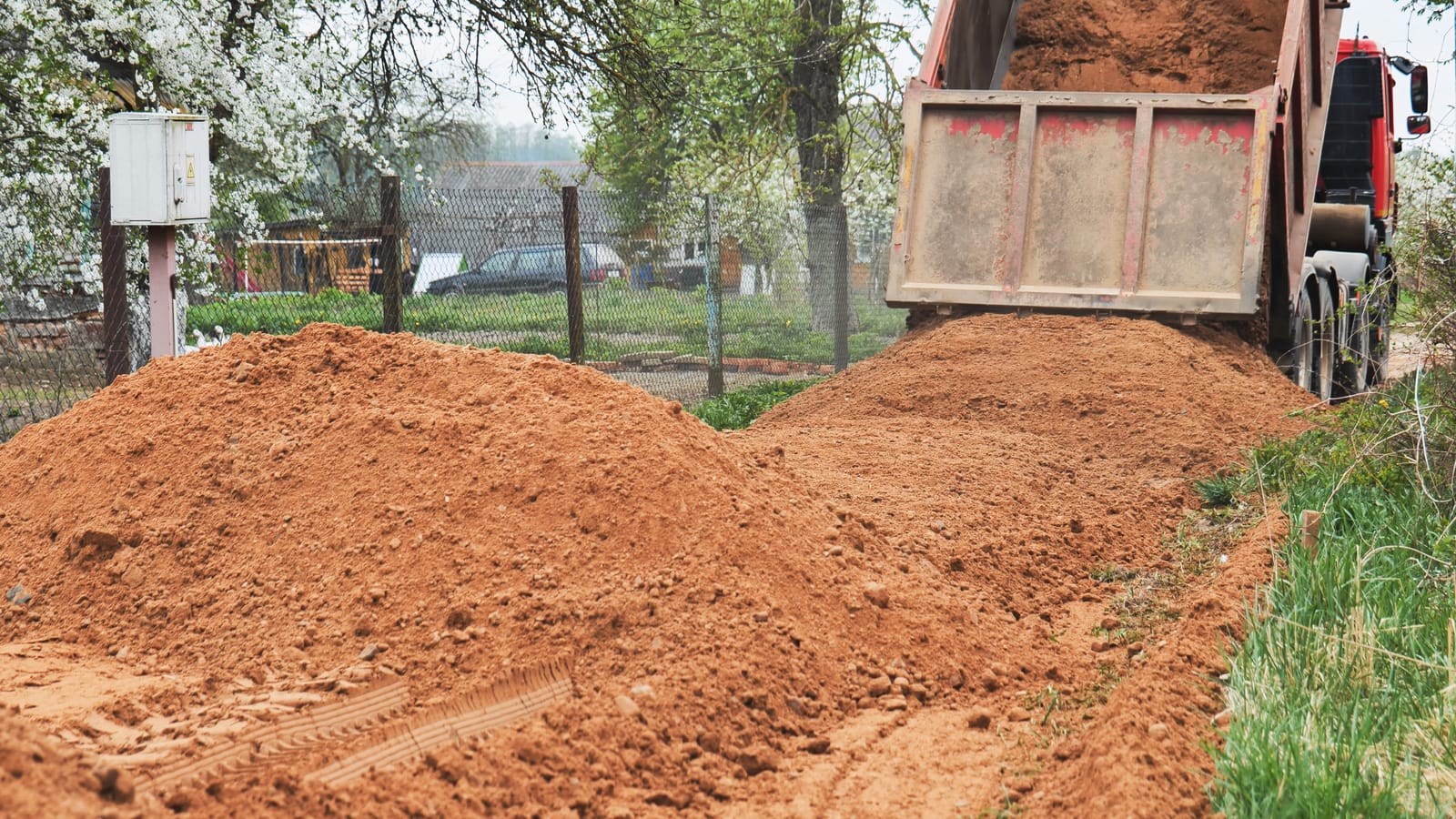 Kamion istovaruje materijal za zemaljske radove